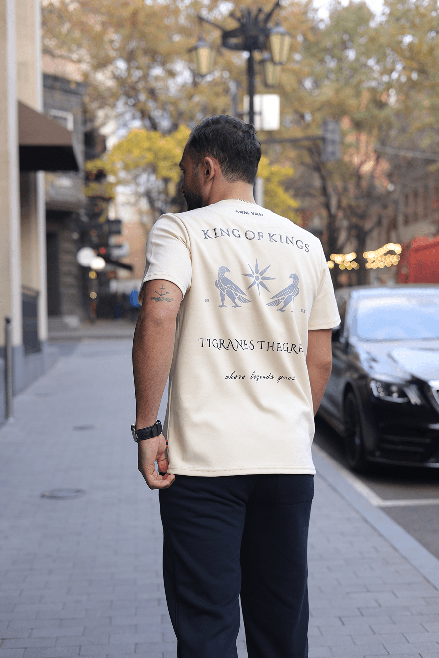 Model wearing ARMYAN EXCLUSIVE cream tee — studio campaign portrait
